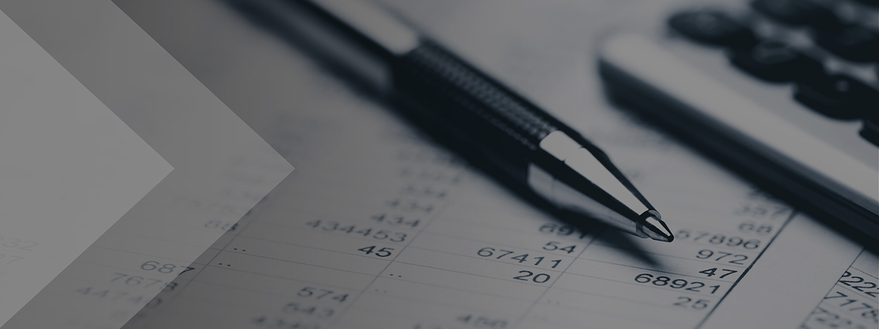 Pen and calculator sitting on top of printout of tax calculations